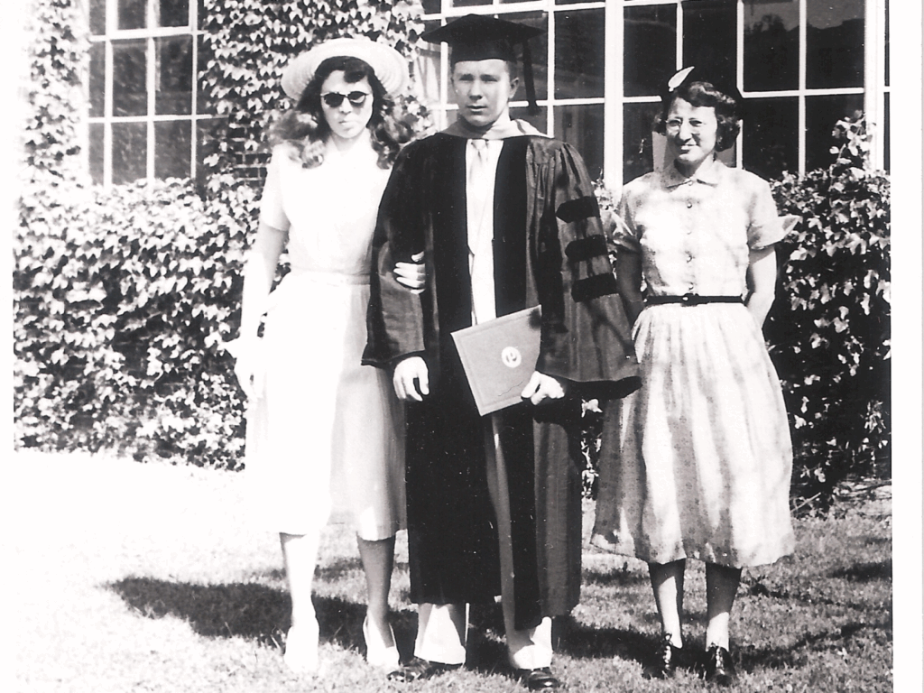 Charlie Danaher In May 2025 Cold Facts: 'A Salute To An Old Friend, Glen Mcintosh' 3 A black-and-white photo of three people standing in front of a windowed building with ivy-covered walls. The person in the center wears a graduation cap and gown, holding a diploma. The two others, dressed in mid-20th-century attire, stand on either side, one wearing a hat and sunglasses, the other in a belted dress with a small headpiece.