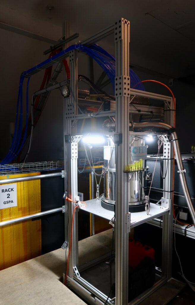 Danaher Cryo In Cold Facts: Nasa Inches Closer To Martian Laser Communication 4 A 1 kelvin cryostat receiver system mounted on an aluminum support frame inside caltech's palomar observatory, used to capture laser light transmitted from nasa's psyche spacecraft approximately 300 million miles away. Blue and orange cables connect to associated electronics labeled rack 2 gspa.